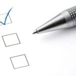 Photo of a pen and a checked off box. Photo of a pen and a checked off box.