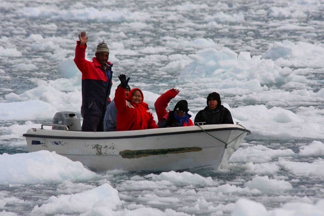 This Inuit family enjoys an outing on the Arctic Sea, which is home to seals and other animals on which they rely for their subsistence. Photo Credit: Bob Corell