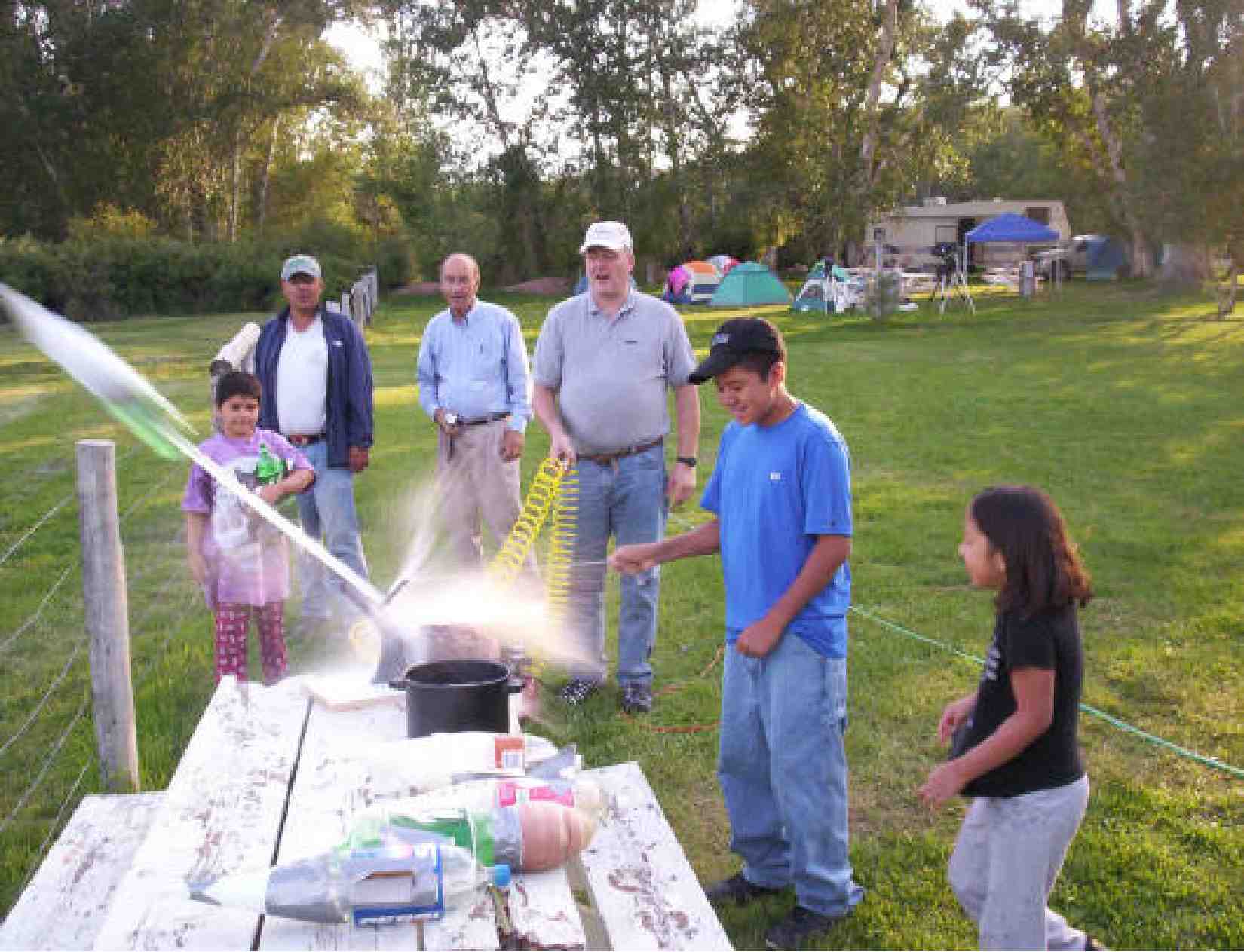 Students and staff at Summer Camp 2006 launching bottle rockets using water.