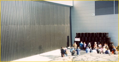 Opening Ceremony of solar wall at Weledeh Catholic School in Yellowknife, Canada. The oil barrels in the back represent the amount of oil the solar air heating system saves each year.