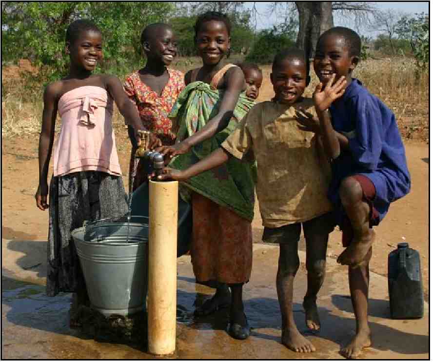 Image of smiling children by a watering hole.