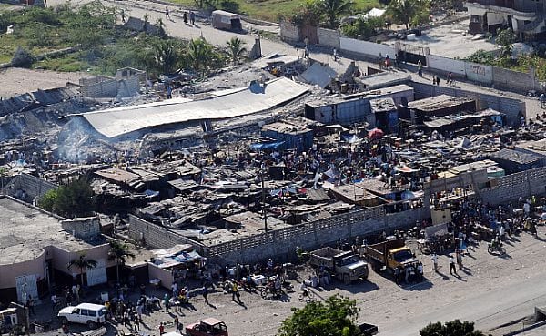 PORT-AU-PRINCE, Haiti (Jan. 15, 2010) Haitian citizens gather in a severely damaged compound in Port-Au-Prince, Haiti, three days after the country suffered a 7.0 earthquake disaster on Jan. 12. (U.S. Navy photo by Mass Communication Specialist 2nd Class Candice Villarreal/ Released)