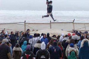 A community celebration of a successful spring subsistence harvest of bowhead whales includes a traditional blanket toss using the boat skins from the successful crew as the blanket. (Spring 2006; photo by Susan Rutland)