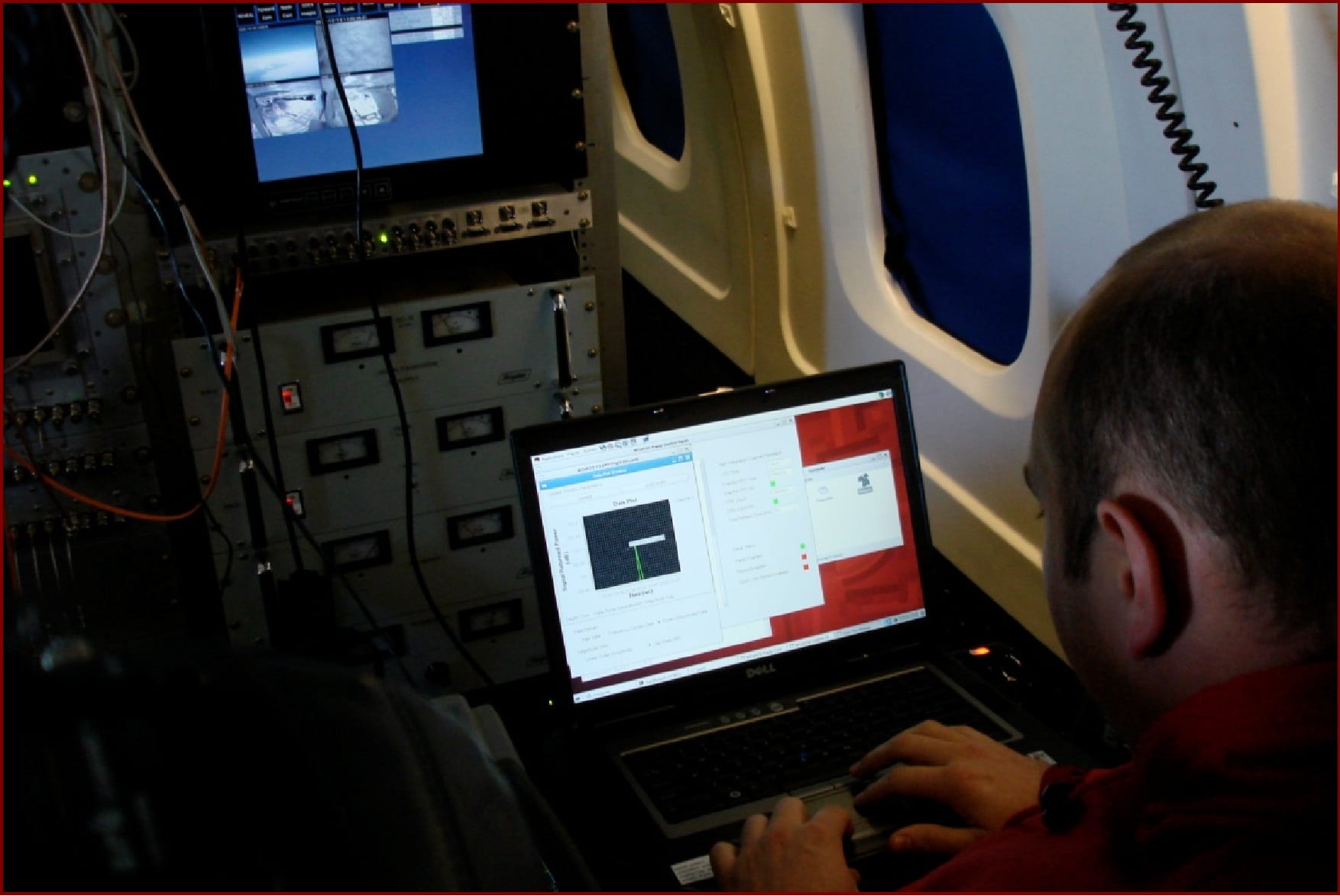 image of CReSIS graduate student William Blake operates a radar system on board the NASA DC-8 during the fall 2009 OIB field campaign in Antarctica. Credit: CReSIS