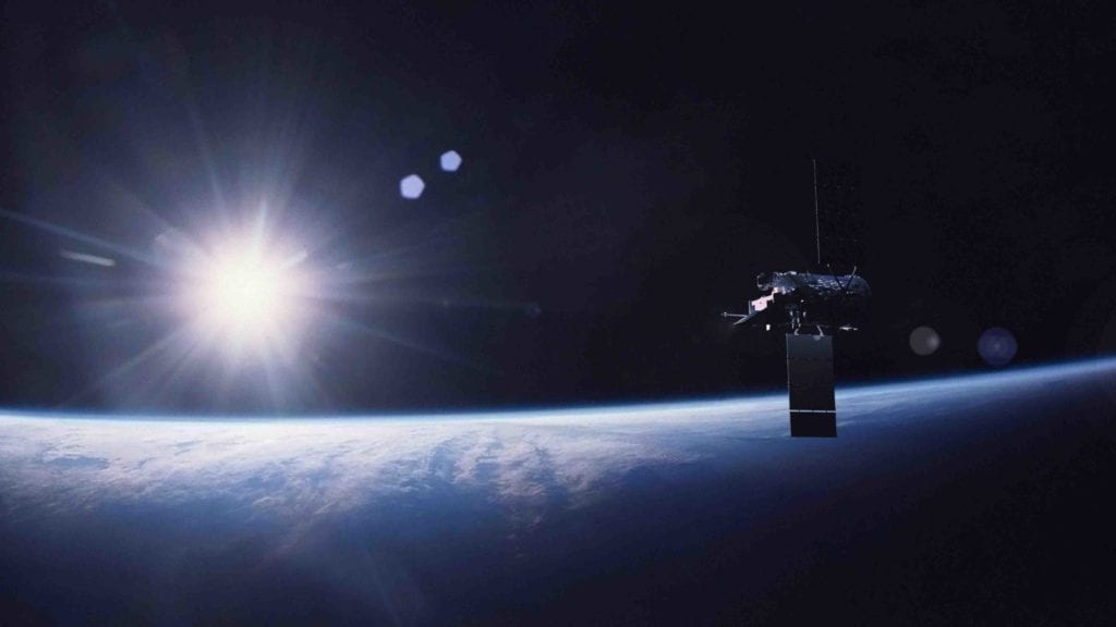 Artist's rendition of the Glory satellite with sun setting in the background.