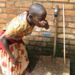 Photo of girl drinking water in Rwanda