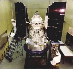 Picture of Landsat 3 being worked on in a clean room