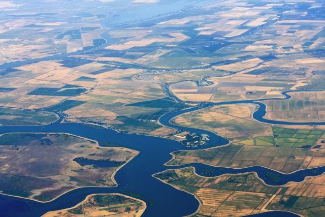 Aerial view of agriculture land with lakes and streams for irrigation.