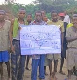 Villagers in the Democratic Republic of Congo hold up a map created during a GPS mapping project. Credit: The Rainforest Foundation/Mapping for Rights