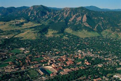 Aerial view of Boulder Colorado with the Rocky Mountains in the background.