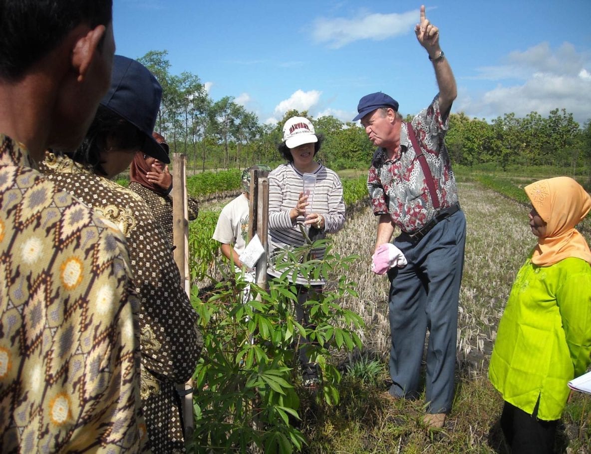 Prof. Yunita T. Winarto (with rain gauge) and Prof. Kees Stigter discuss rainfall measurements with farmers from Wareng, Gunungkidul, Yogyakarta Special Province, Indonesia. Photo courtesy of authors.