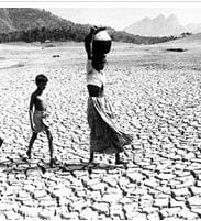 Image of a woman and child walking across a barren landscape. Credit: ZeeNews