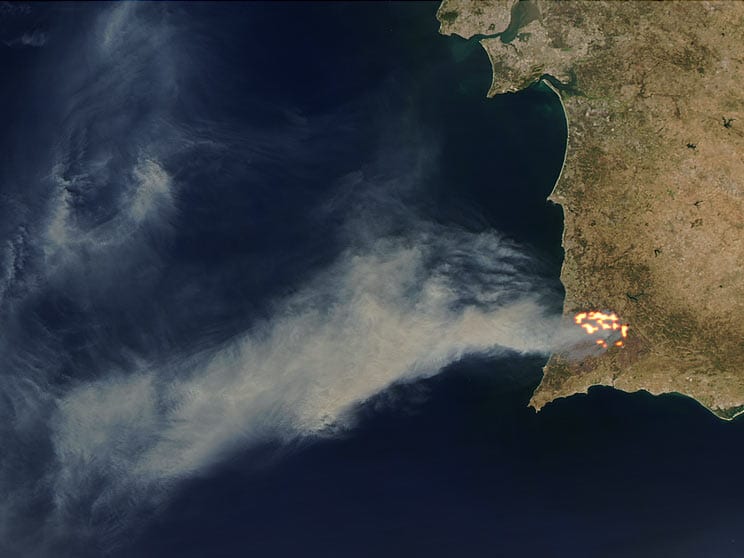 A plume of smoke drifts westward over the Atlantic Ocean from a massive forest fire in southwestern Portugal in this Moderate Resolution Imaging Spectroradiometer (MODIS) image from the Aqua satellite.  Credit: Jeff Schmaltz, MODIS Rapid Response Team, NASA GSFC.