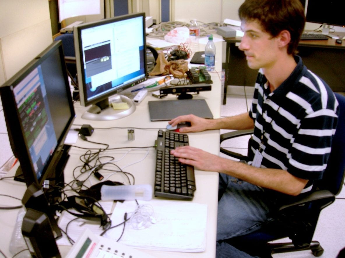 Electrical engineering researcher Jordan Fuchs tests his software creation. Image Credit: URC.