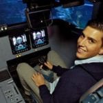 Photo of Gregory MOrales in the cockpit of a plane. Image Credit: URC