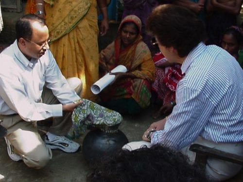 Dr. Anwar Huq, left, and Dr. Colwell in Bangladesh demonstrate how to filter drinking water using everyday sari cloth. Image Credit: Rita Colwell. 