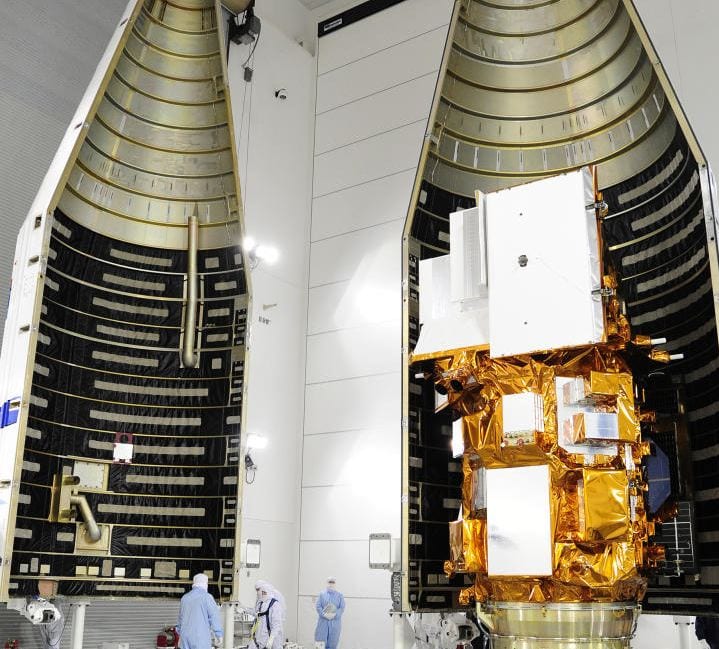 Technicians encapsulate the NASA's LDCM satellite in its payload fairing. (Credit: NASA/VAFB)