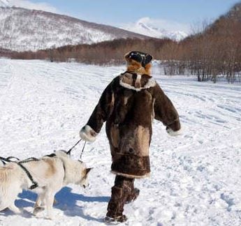 Photo of an Inuit hunter and their dog. Credit: The Ecologist