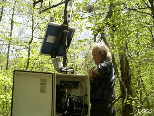 Dr. Douglas Muchoney working on a weather station. Image Credit: Cindy Cunningham , USGS.