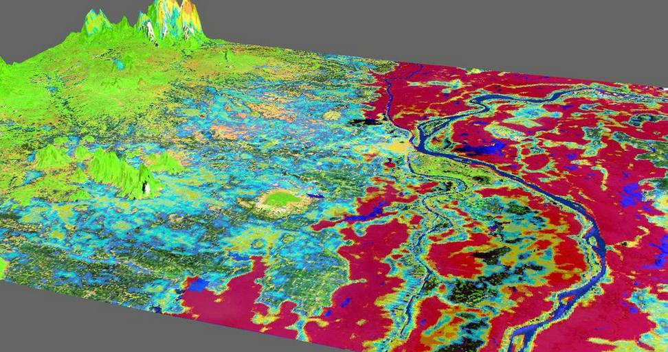 The flood detection product (intensity in a range from blue to red) overlaid on a false-color Landsat scene over the capital city of Cambodia. Image Credit: Southeast Asia Disasters Team. 