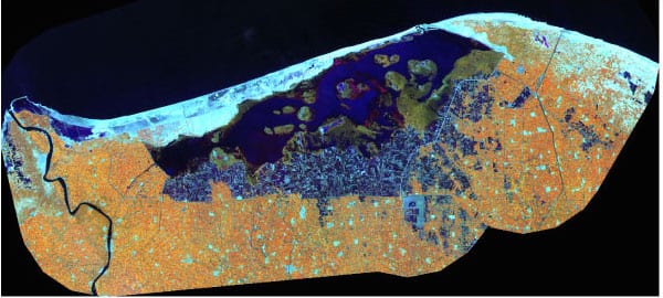 Lake Burullus on a Landsat 5 image acquired on March 29, 2005. Orange represents irrigated agriculture, blue is aquaculture, green is reed beds and salt marshes, light blue is beaches and sand plains, dark blue is open water. Image Credit: Landsat 