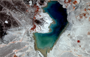 RapidEye satellite image of Azraq from April 4, 2010. Red depicts agricultural areas, black is basaltic stone desert, white is sand or limestone, blue is seasonally inundated areas, and the black area in the center represents reed bed, shrubs, and small permanently inundated areas around three springs. Image Credit: RapidEye