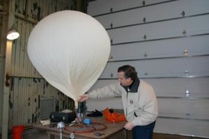 Inflating a balloon for upper-air observation. Image Credit: NWS Weather Forecast Office, Green Bay, Wisconsin