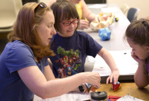 Dr. Hilary Smith Risser works with girls at the Create Math summer camp at Montana Tech in Butte, Montana, this summer to use mathematics to create origami models. Image Credit: David Nolt, Montana Tech