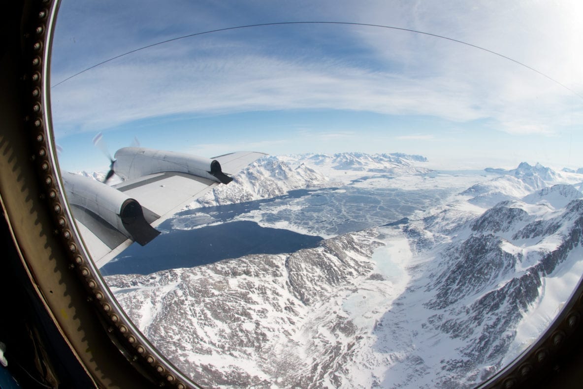 Icy water in the fjord of the Kangerdlugssuaq Glacier in eastern Greenland, as seen from NASA's P-3B aircraft on April 14, 2012. The wire seen at the top of the frame is a high frequency radio antenna attached to the aircraft, and appears curved due to the use of a fisheye lens when taking the photograph. Credit: NASA/Jefferson Beck.