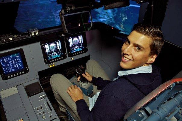 Photo of Gregory MOrales in the cockpit of a plane. Image Credit: URC