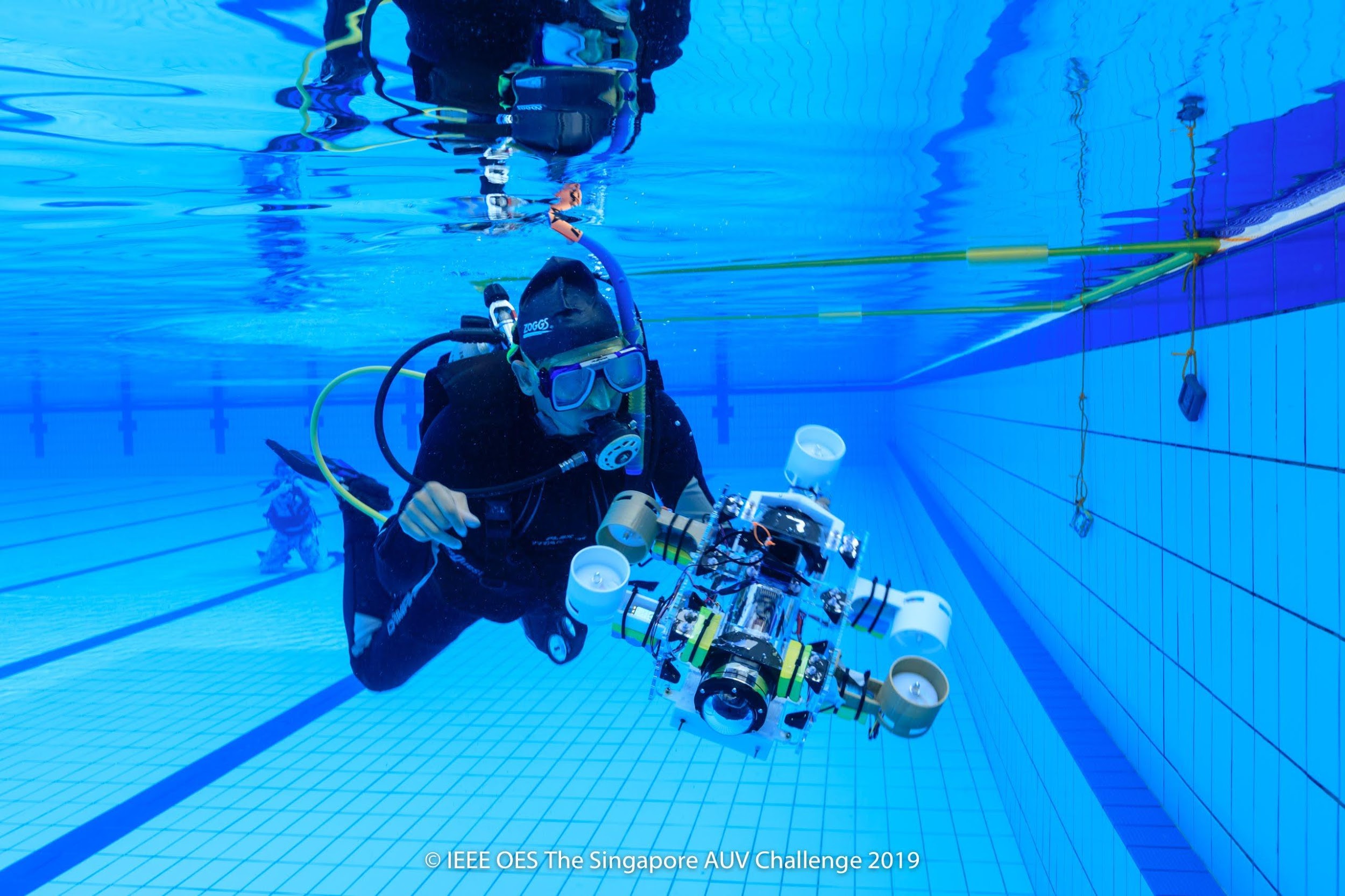 One of the divers at SAUVC, Dr. Mandar Chitre, retrieves Team Bubbles’ (SUTD) AUV
