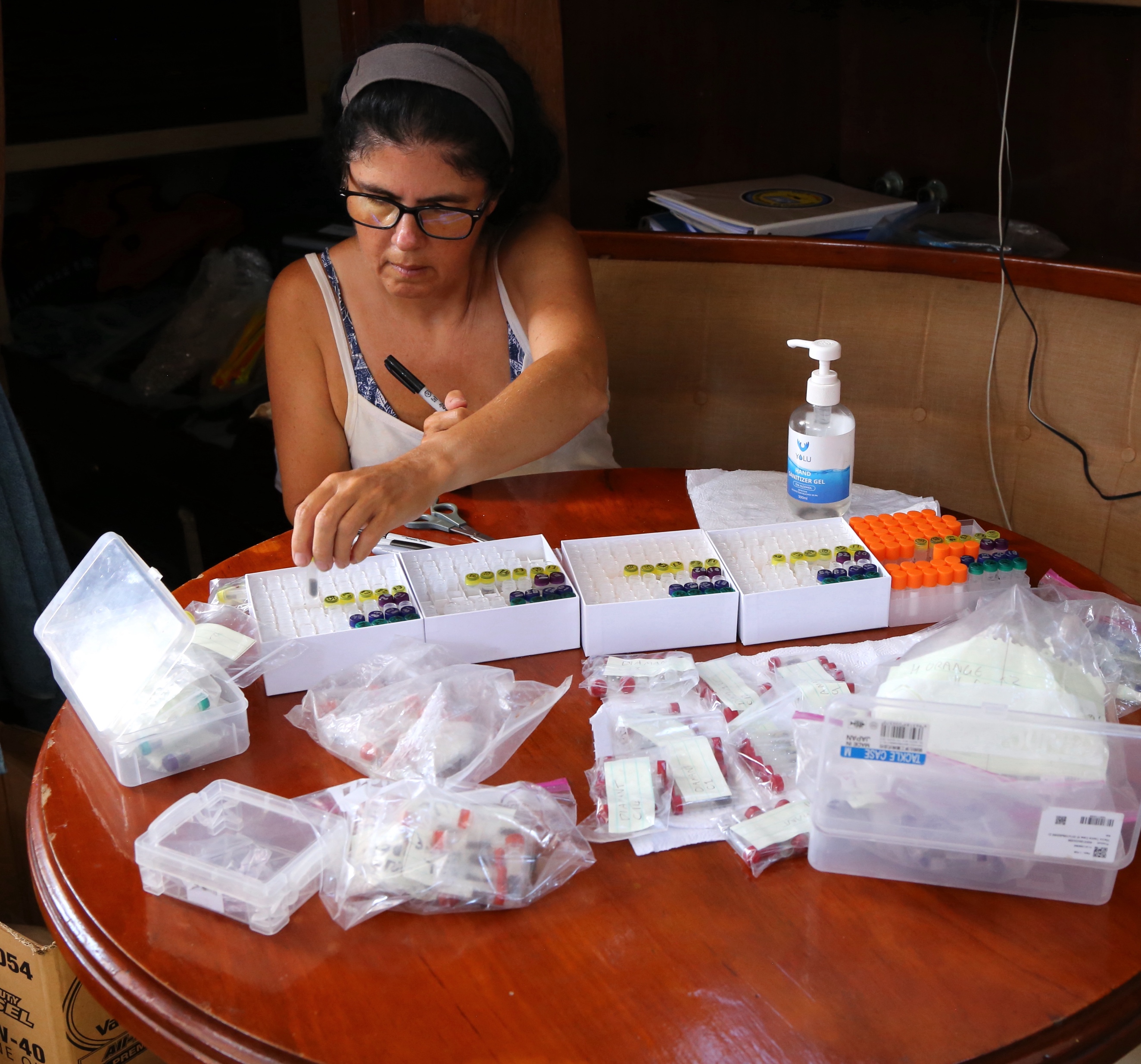 Sorting rat DNA samples for storage and distribution to various analysis laboratories (right) on board Jocara.