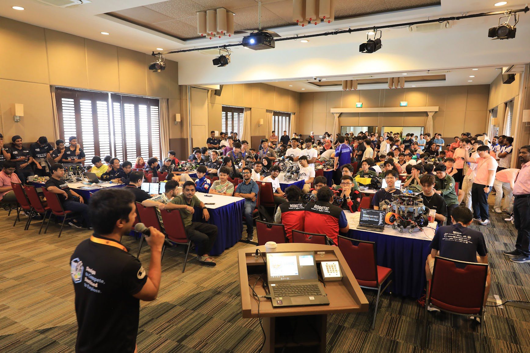 Teams being given briefings on the event in a fully packed hall