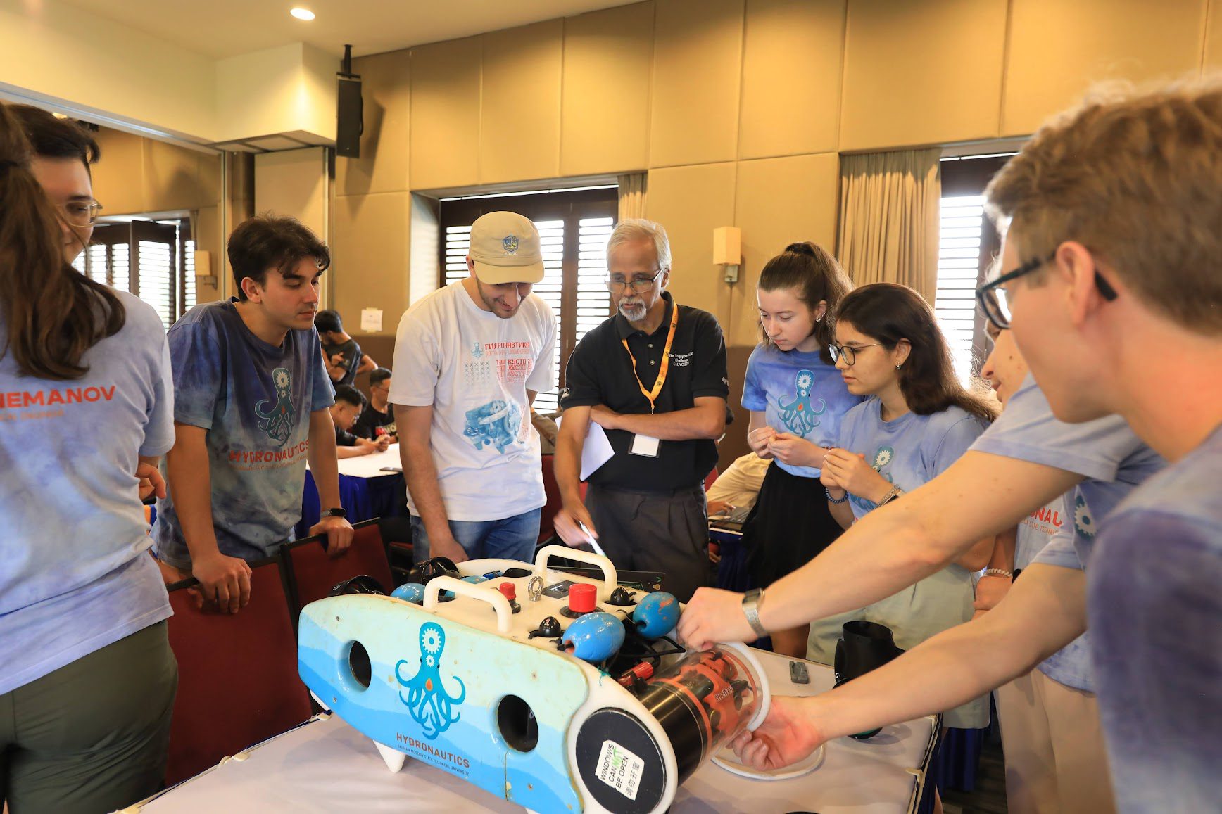 Judge Venu interacting with teams, judging the Innovation award